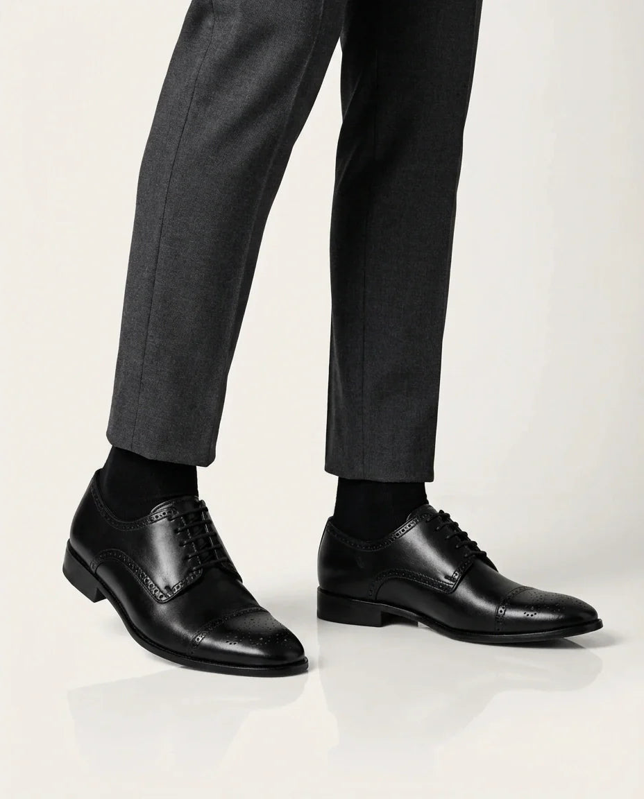 Regal Black worn with gray pants on a white background