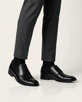 Regal Black worn with gray pants on a white background