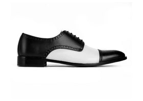 Side profile of Bold Brogue dress shoes showing black and white contrast design with elegant formal silhouette