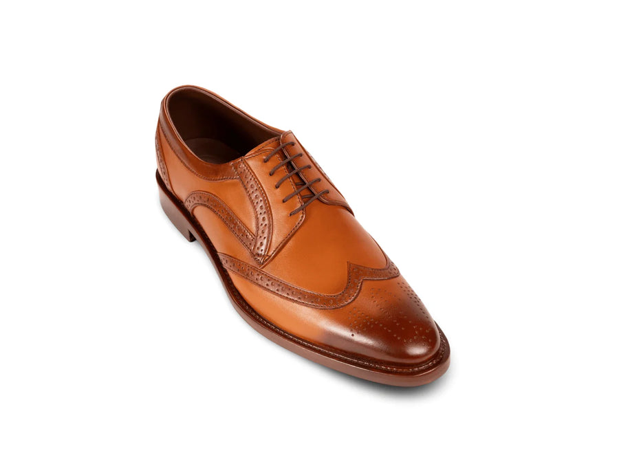The Shelby Brogue men’s cognac wingtip brogue dress shoe three-quarter view