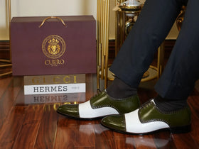 Artistic close-up of Ebony and Ivory brogue shoes highlighting green suede, white contrast, and premium craftsmanship detail