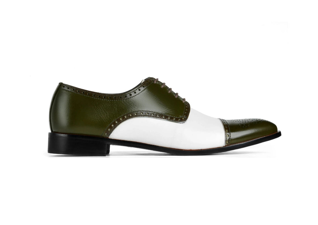 Side profile of Ebony and Ivory brogue shoes showing green suede upper and white contrast detailing with formal silhouette