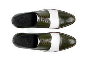 Top view of Ebony and Ivory brogue shoes showing lace structure, perforated detailing, and bold green and white contrast design