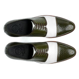 Top view of Ebony and Ivory brogue shoes showing lace structure, perforated detailing, and bold green and white contrast design