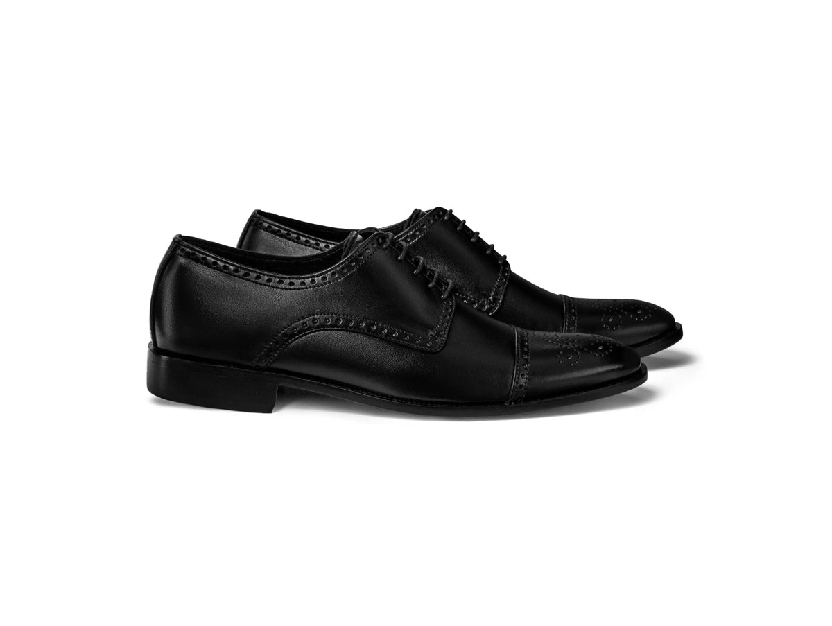 Regal Black oxford shoes angled lifestyle view black leather formal shoe white sole