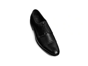 Close up detail of Regal Black oxford shoe toe and lace design premium leather craftsmanship